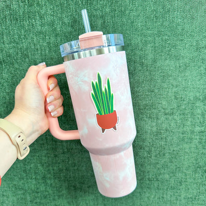 snake plant sticker on a tie dye Stanley water bottle held by a manicured hand on green background